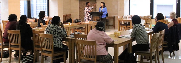 The Revs. Beauty Maenzanise (left) and HiRho Park explain the agenda to the participants of African and Asian Women Theologians Conference held Aug. 12-15 in Seoul, Korea. Photo by the Rev. Thomas Kim, UM News.