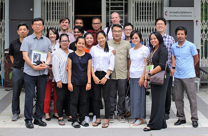 Members of the Cambodia Human Trafficking Consultation Mission team gather in front of the United Methodist Board of Global Ministries office in Phnom Penh. The team included six Korean American United Methodists and seven staff members from Global Ministries. Photo by the Rev. Thomas Kim, UM News.