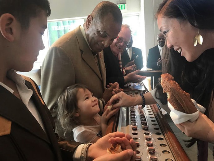 The Rev. Allison Mark (right), senior pastor at Faith United Methodist Church in Torrance, Calif., serves communion to a young girl. Photo courtesy of Faith United Methodist Church.