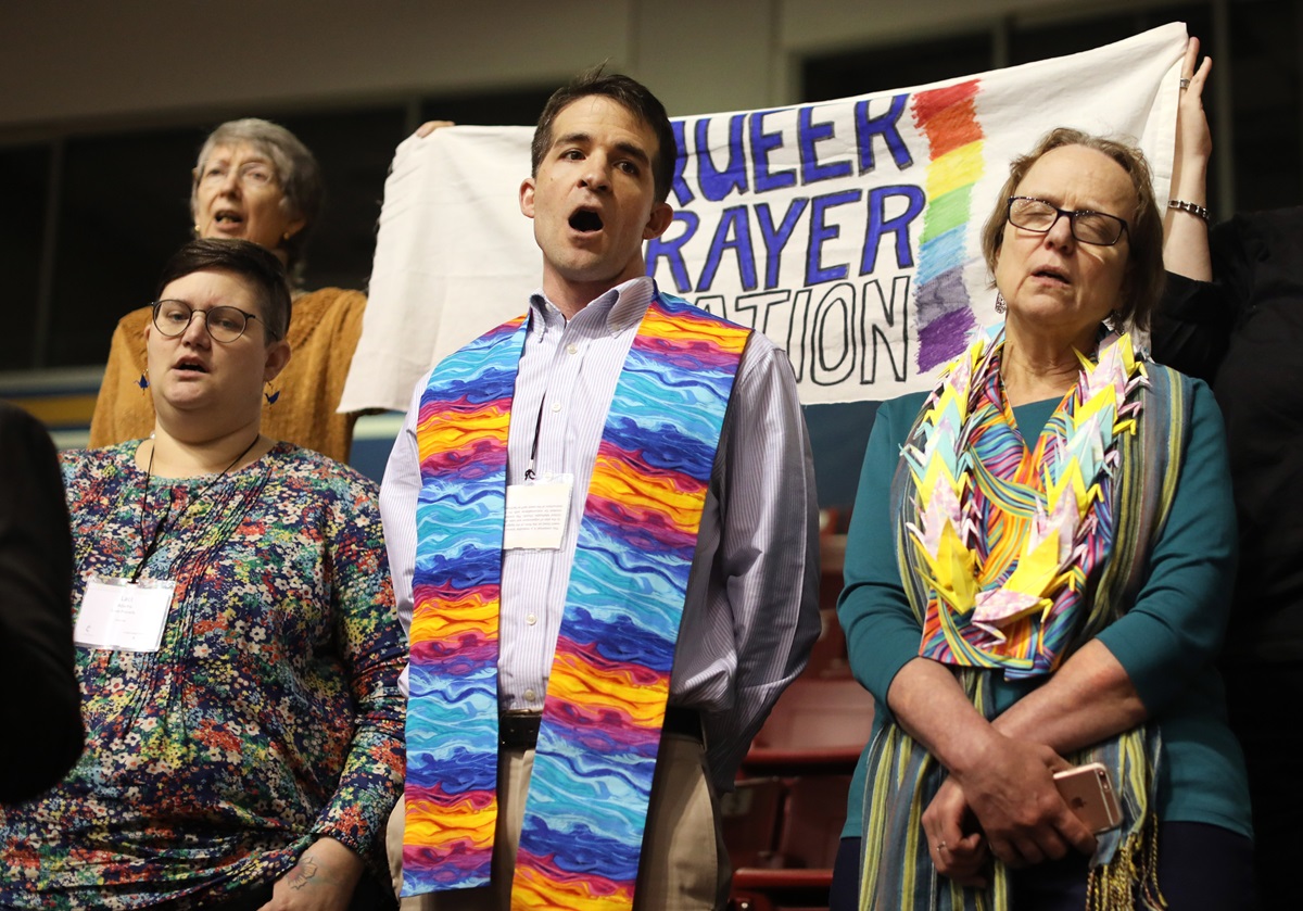 The Rev. Will Green (center) leads the singing of "Jesus Remember Me When You Come Into Your Kingdom" at the "Queer Prayer Station" during the Feb. 23 morning of prayer at the 2019 Special Session of the United Methodist General Conference in St. Louis. Green serves one of nine New England churches looking into leaving the denomination. Photo by Kathleen Barry, UMNS.