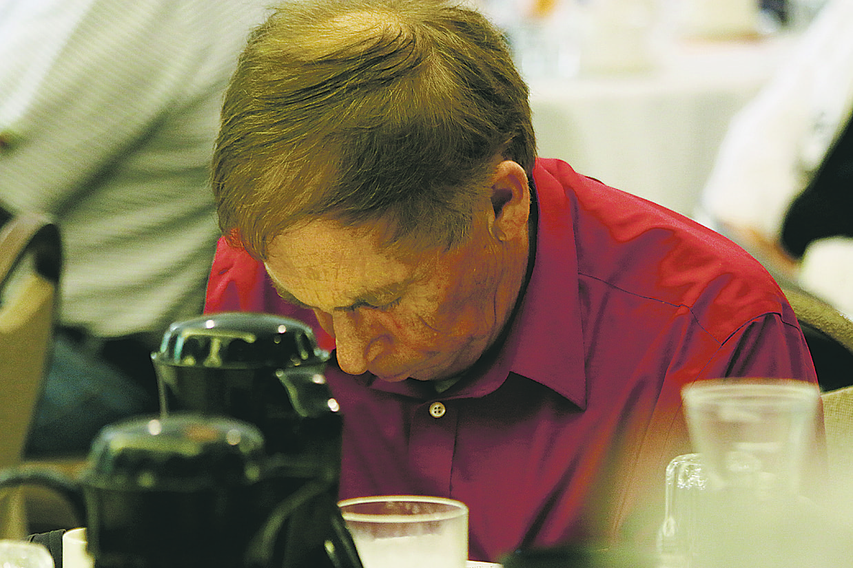 Dennis Valstad pauses in prayer during an event at Immanuel United Methodist Church. Photo courtesy of Ripon Commonwealth Press-Express.