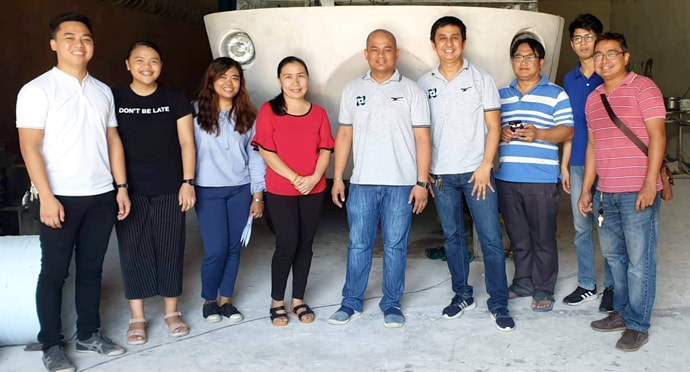 Ryan John de Lara (center), a member of United Methodist City Temple in Cabanatuan City, poses with other researchers in front of the rescue vehicle he helped create. He serves as director of engineering research and productivity at Wesleyan University-Philippines. Photo courtesy of Ryan de Lara.