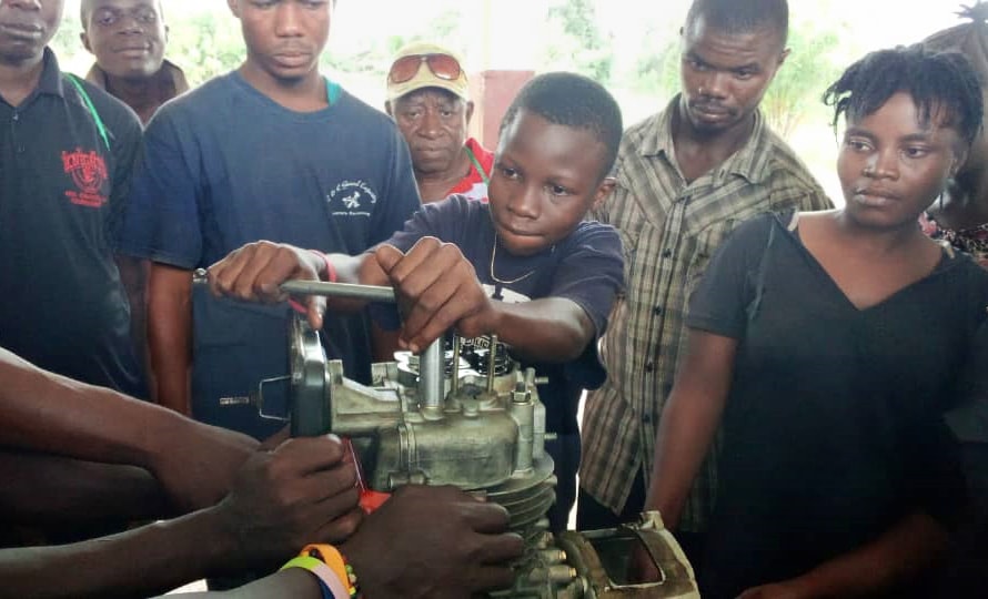 Peter Alfred Jusu, 15, works on a generator engine during hands-on training at the new Taiama Enterprise Academy in Taiama, Sierra Leone, on Oct. 15. Envisioned four years ago, the school is a hybrid of hands-on vocational and entrepreneurship training designed to address the problems of unemployment and poverty. Photo by Duramani Massavoi, Taiama Enterprise Academy.