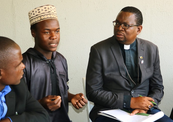 A youth member of the Islamic community and Bishop Eric Ruwona of the Anglican Diocese of Manicaland participate in interfaith dialogue calling for men and boys' involvement in the fight against HIV in Zimbabwe. Photo by the Rev. Taurai Emmanuel Maforo, UM News.