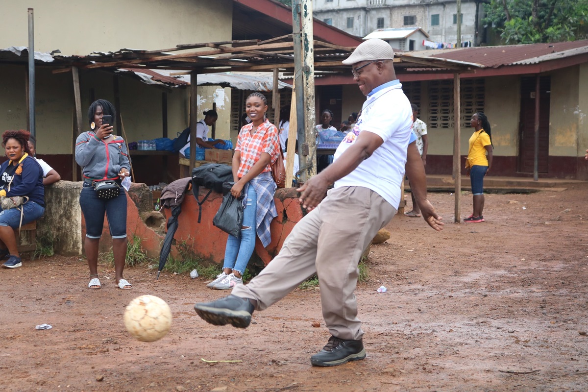 The Rev. Julius Sarwolo Nelson kicks the ball during a soccer match between youth and young adults in Monrovia, Liberia.  A scholarship fund to help young people in rural communities has been named after Nelson, who is an elder at Refuge United Methodist Church. Photo by E Julu Swen, UM News. 