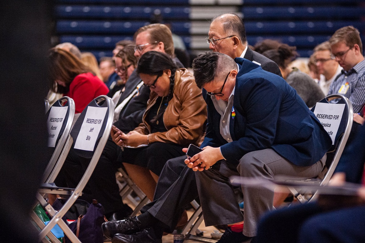 The Rev. Jessica Winderweedle (right) joins in prayer with other members of the Greater New Jersey Way Forward Team during a special session of their annual conference at Brookdale Community College in Middletown, N.J. Photo by Corbin Payne.