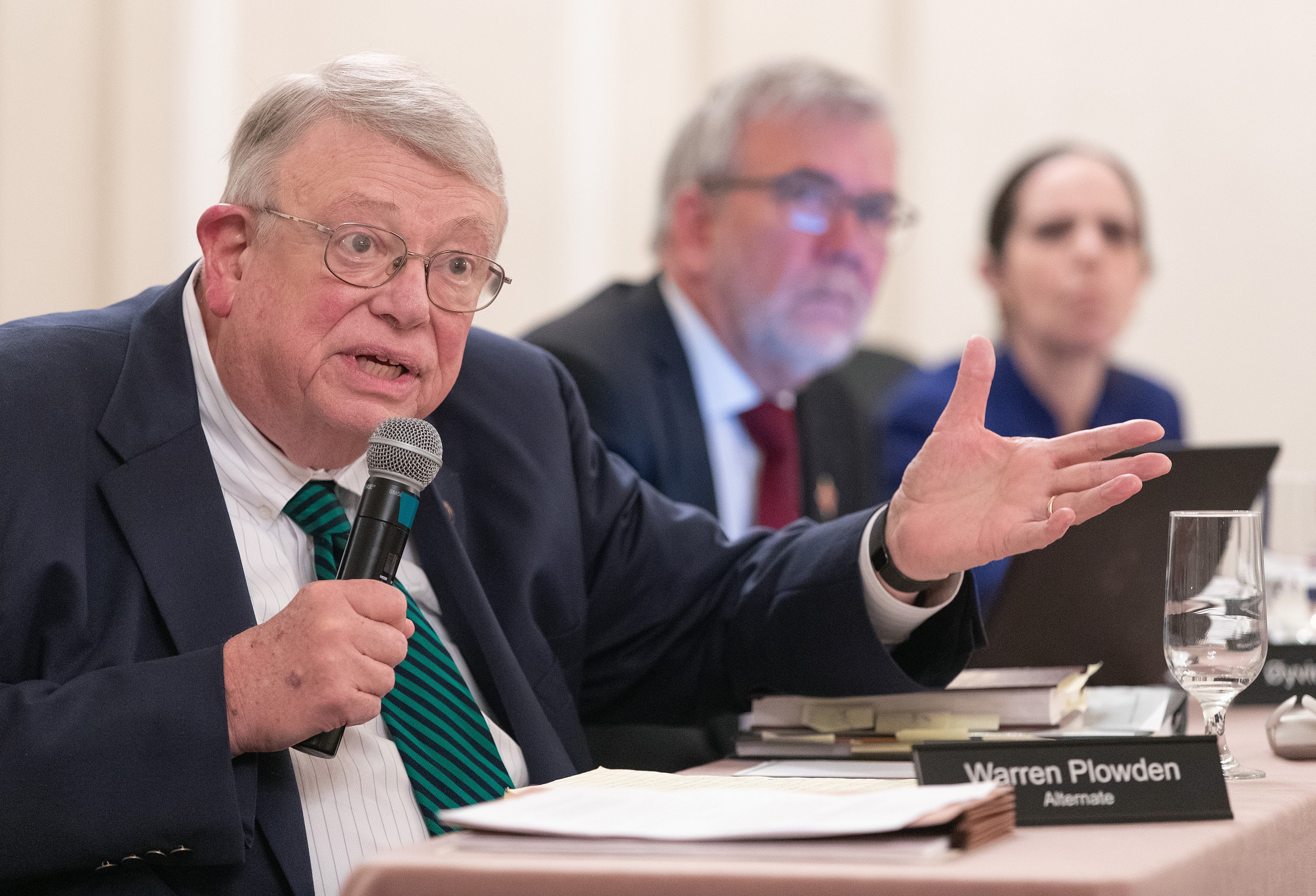 United Methodist Judicial Council member Warren Plowden (left) asks a question about the investigation of improper voting during the 2019 United Methodist General Conference. He was questioning Bishop Kenneth H. Carter, president of the denomination's Council of Bishops, and William Waddell, the council's legal advisor, during an oral hearing at the Judicial Council meeting in Evanston, Ill. Photo by Mike DuBose, UM News.