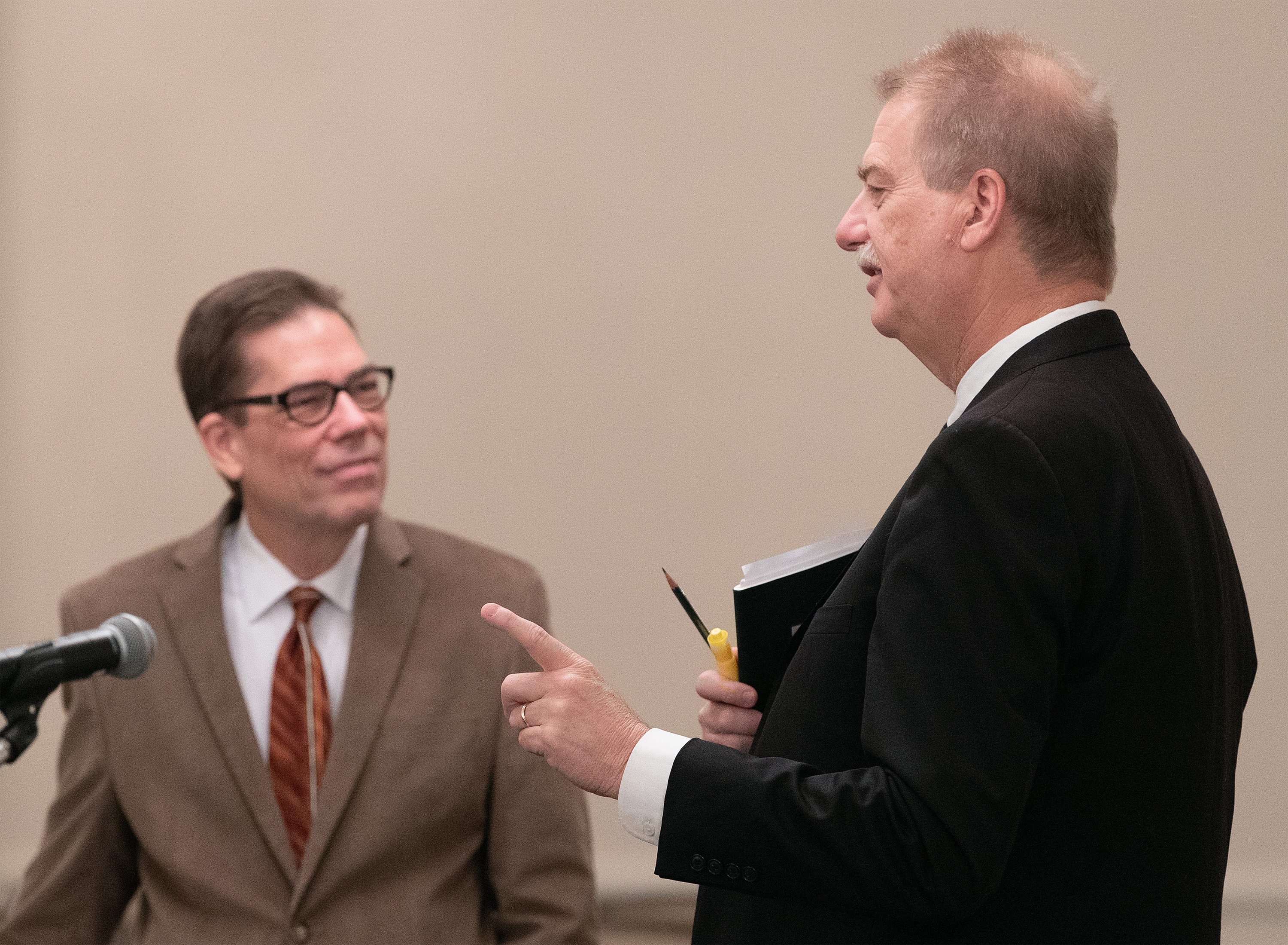 The Rev. Tom Lambrecht (left) and Bishop Kenneth H. Carter visit prior to the start of oral hearings before the United Methodist Judicial Council meeting in Evanston, Ill. Lambrecht is vice president and general manager of Good News and a member of the Wesleyan Covenant Association leadership. Carter is president of the denomination's Council of Bishops. Photo by Mike DuBose, UM News.