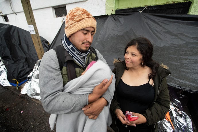 Jesús and his pregnant wife, Mariana, care for their 1-year-old daughter, Kataleya, at a tent camp in Juárez, Mexico, where they and dozens of other migrants are waiting for an appointment with U.S. immigration officials to request asylum in the U.S. The young family has been living in a two-person camping tent for two months. They are among some 16,000 asylum seekers who are stranded in Juárez following implementation of the Trump administration’s Migrant Protection Protocols, which force asylum seekers to stay in Mexico while they wait for their immigration proceedings. Photo by Mike DuBose, UM News.