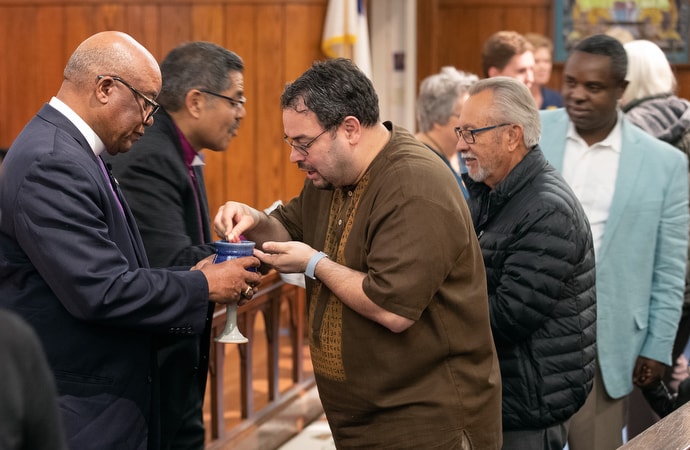 United Methodist Bishop W. Earl Bledsoe (left) and Bishop Felipe Ruiz Aguilar of the Methodist Church of Mexico serve Holy Communion during closing worship for the United Methodist Immigration Summit at Trinity-First United Methodist Church in El Paso, Texas. Photo by Mike DuBose, UM News.