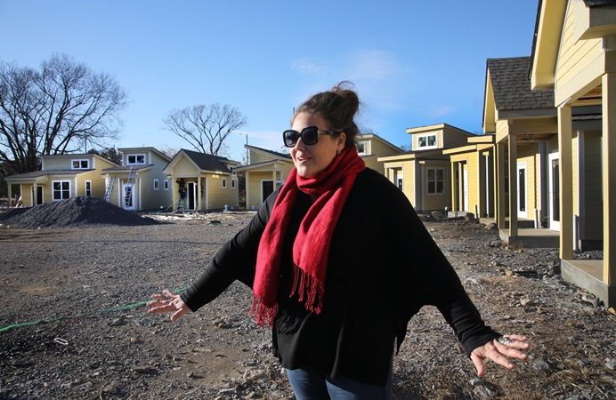 The Rev. Ingrid McIntyre shares the story of the micro house community for homeless respite care under construction at Glencliff United Methodist Church in Nashville, Tenn. Photo by Kathleen Barry, UM News.