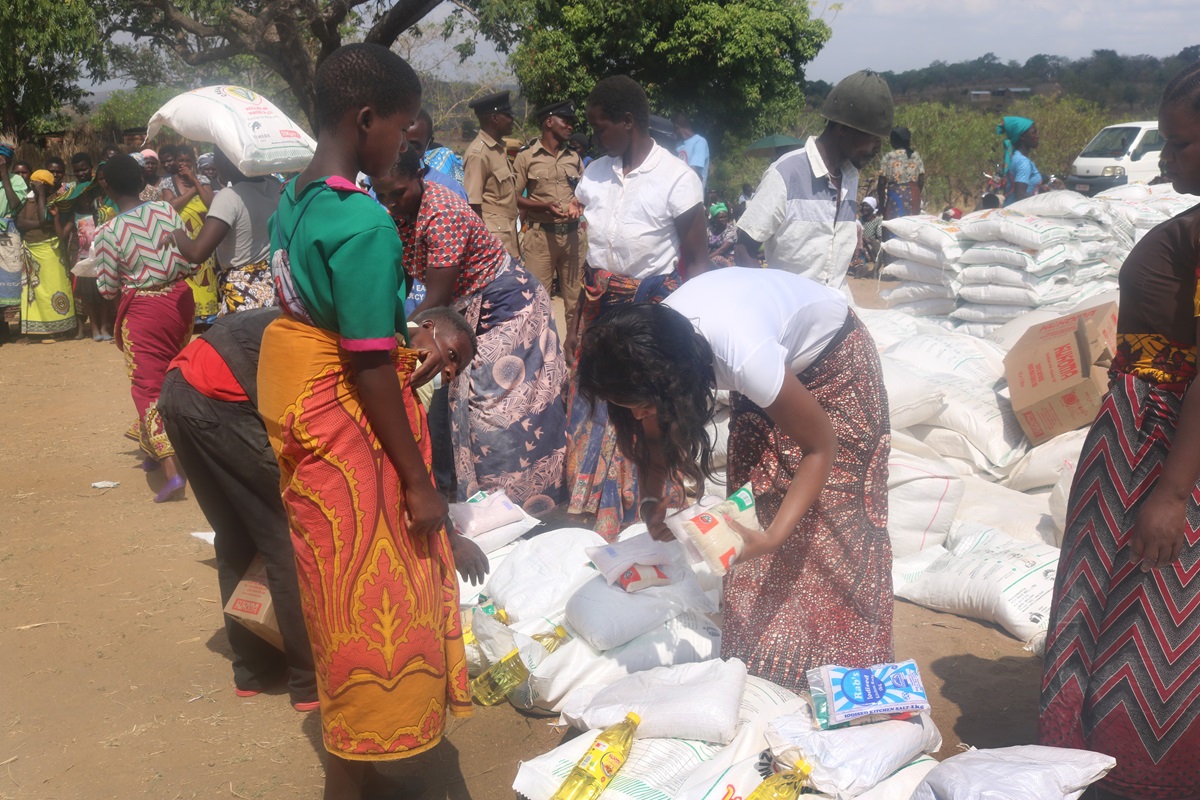 Disaster relief volunteers with The United Methodist Church in Malawi hand out supplies to Cyclone Idai survivors in the Ntcheu District. More than 1,000 households from seven villages received food, including maize flour, cooking oil, beans, sugar and salt. Many in the area lost their crops to flooding after the deadly March 14 storm. By Francis Nkhoma, UM News.