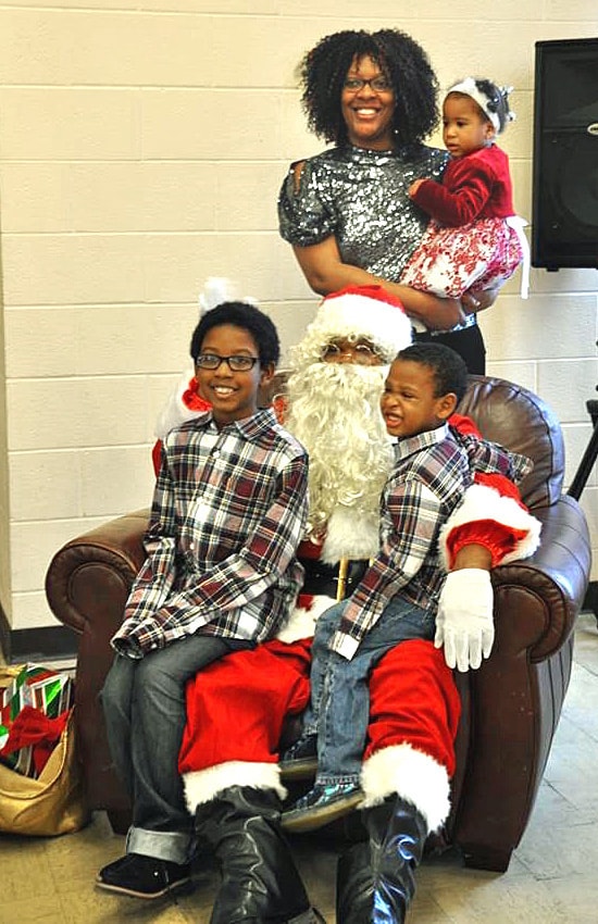 A family poses with Santa during a Christmas event at Garfield Memorial Church near Cleveland, Ohio. The multi-ethnic, multi-campus United Methodist church hosts different holiday events to share the joy of Christmas with its community. Photo courtesy of Garfield Memorial Church.