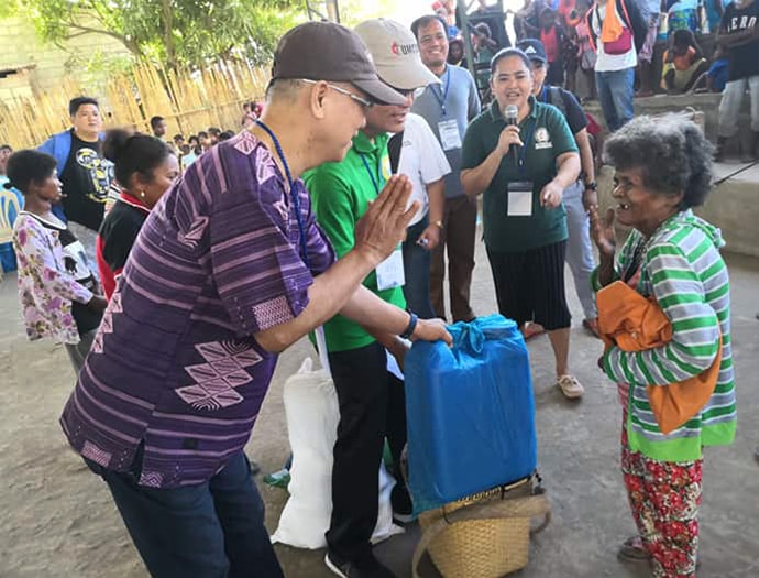 Manila Area Bishop Ciriaco Q. Francisco (left) and Jestril Alvarado, West Pampanga District superintendent, help distribute food to Aeta communities in Floridablanca in the Pampanga province of the Philippines. The United Methodist Committee on Relief issued a $100,000 grant to provide support for 860 indigenous families affected by a deadly earthquake. Photo by the Rev. Gilbert Cedillo. 