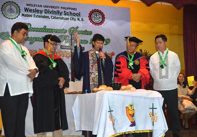 Bishop Pedro M. Torrio Jr. (center) officiates Holy Communion during the Jan. 25, 2019, Baccalaureate service at Wesley Divinity School of Wesleyan University in Cabanatuan City, Philippines. From left are the Rev. Francis Fajardo, the Rev. Sergio E. Arevalo Jr., Torio, Johnson Mones and Willy Ramos. Photo courtesy of the Rev. Sergio E. Arevalo Jr.