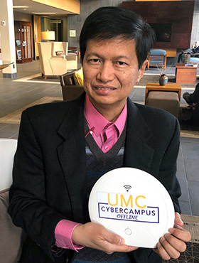 Bishop Pedro M. Torio Jr. of the Baguio Area in the Philippines shows off the first United Methodist Church Cyber Campus Offline device, which he received for his area in November. The gadget is designed for United Methodists with limited internet access who live far from the church’s schools, seminaries and universities. Photo by the Rev. HiRho Park, United Methodist Board of Higher Education and Ministry.  