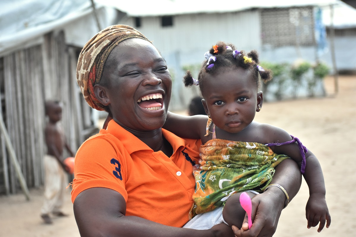 Josiane Bahi, 33, holds her 1-year-old granddaughter, Grâce Debra, at Ampain Ivorian Refugee Camp in Ampain, Ghana, where Bahi, a United Methodist, has resided since 2012. Her granddaughter was among more than 540 children who received a gift on Christmas Day from The United Methodist Church in Côte d'Ivoire. Photo by Isaac Broune, UM News.