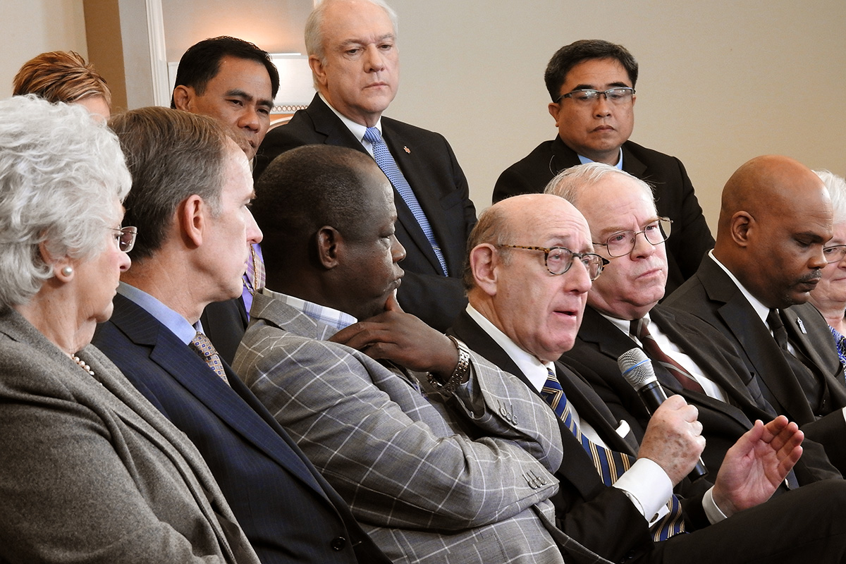 Kenneth Feinberg (holding microphone), speaks during a livestreamed panel discussion in Tampa, Fla., with members of the team that developed a new proposal that would maintain The United Methodist Church but allow traditionalist congregations to separate into a new denomination. Feinberg moderated the work of the team that created the proposal, called the "Protocol of Reconciliation & Grace Through Separation.” Photo by Sam Hodges, UM News.