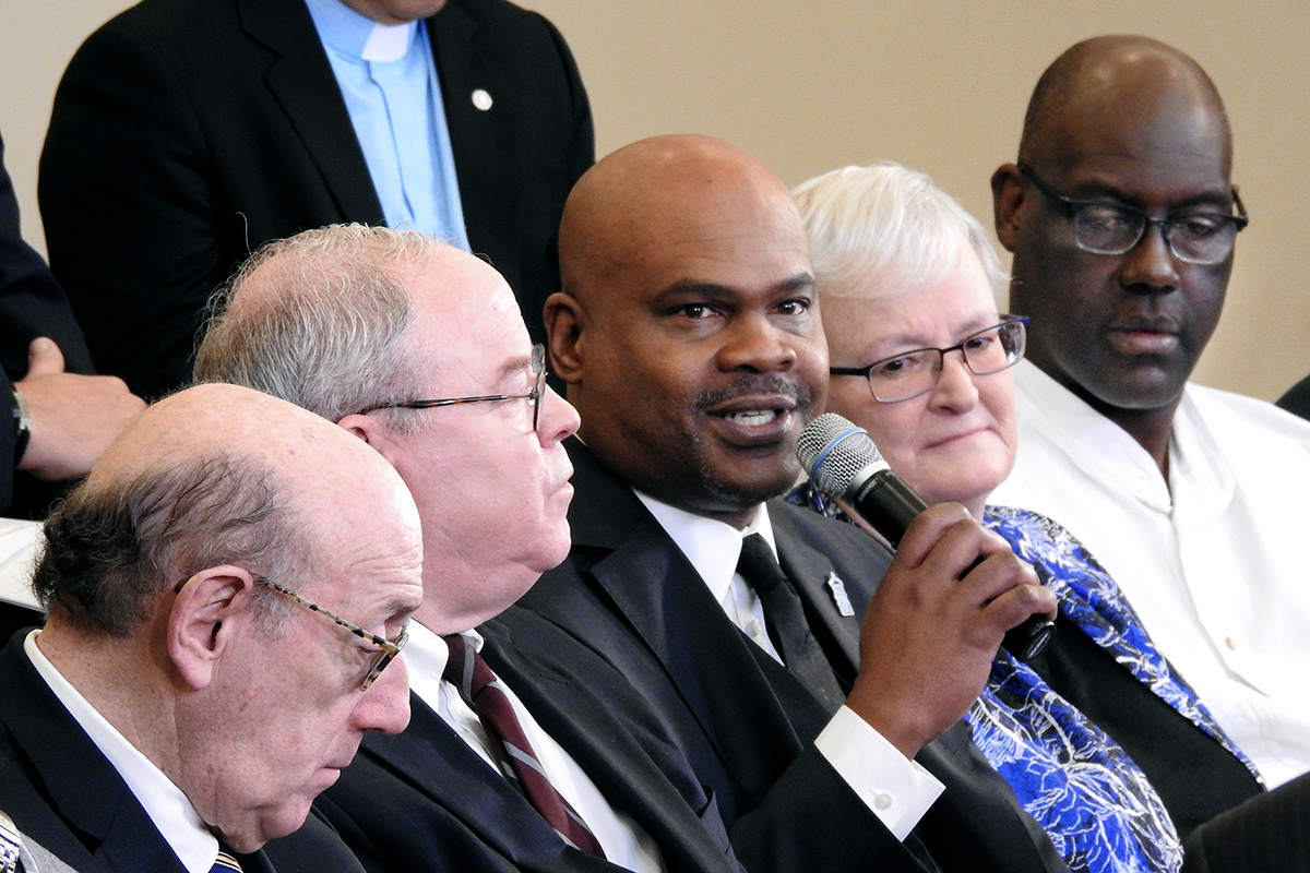The Rev. Junius Dotson (holding microphone), speaks during a livestreamed panel discussion in Tampa, Fla., with members of the team that developed the "Protocol of Reconciliation & Grace Through Separation.” $39 million is set aside in the plan to go to minority churches. “The idea was … to make clear that the church has a commitment to these communities of color,” Dotson said. Photo by Sam Hodges, UM News.