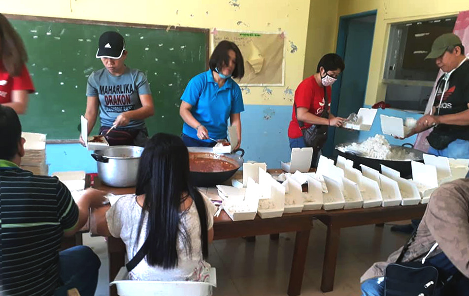 A team from the United Methodist Asuncion Perez Memorial Center in the Mataas Na Kahoy province of Batanga, Philippines, prepares food for relief distribution after the Taal volcano erupted on Luzon Island Jan. 12, leaving an estimated 282,000 people displaced. Photo courtesy of Liza A. Cortez.