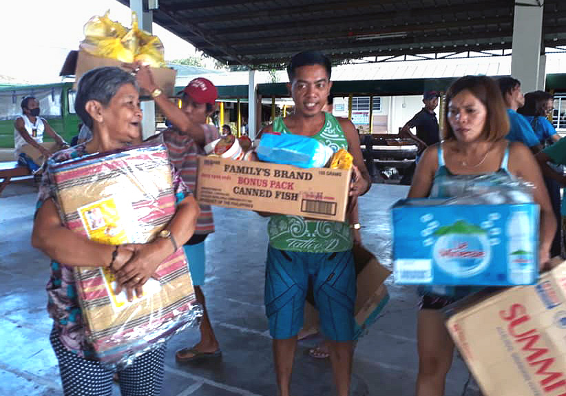 Evacuees in Mataas Na Kahoy in the province of Batangas, Philippines, receive relief goods from the Philippines Central Conference’s Asuncion Perez Memorial Center. United Methodists are among the many people responding to the thousands displaced by the Taal volcano eruption Jan. 12 on Luzon Island. Photo courtesy of Liza A. Cortez.