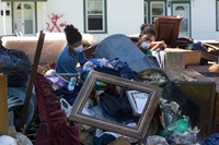 Jeremain (left) and Jeremaih Robinson pile up ruined furnishings from a home that was heavily damaged by flooding in Baton Rouge, La. The 16-year-old twins were part of a volunteer team from First United Methodist Church in Baton Rouge. Photo by Mike DuBose, UM News.