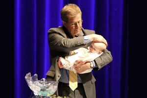 Bishop Scott J. Jones baptizes the daughter of the Rev. Emily and Stephen Cannon during the 2015 Great Plains Annual Conference. Photo by Todd Seifert, Great Plains Conference.