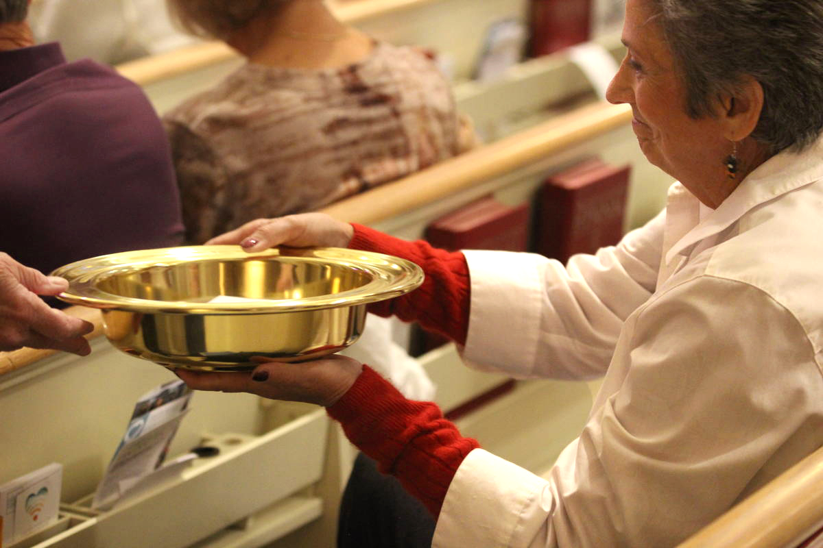 A woman holds an offering plate during a service at Boise United Methodist Church in Boise, Idaho. United Methodist collection rates in 2019 dipped below recent years, but the drop wasn’t as steep as initially projected. Photo courtesy of the Marketing Department, United Methodist Communications.