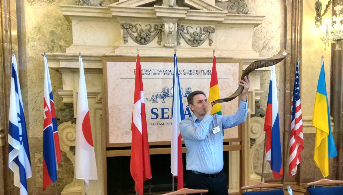 The Rev. Lev Shults plays a traditional horn in the Senate of the Czech Republic during the International Bible Championships. Shults is pastor of Agape United Methodist Church, a Russian-speaking church among 23 local parishes of The United Methodist Church in Czechia. Photo by Urs Schweizer, Central Conference of Central and Southern Europe.