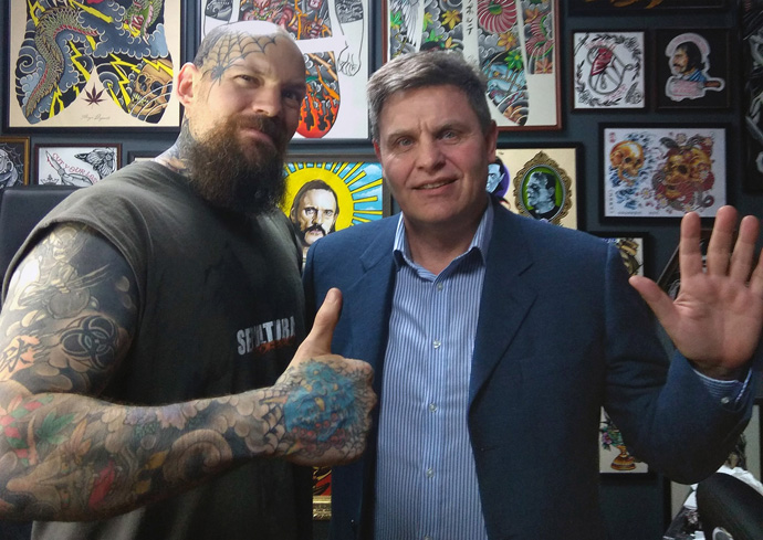 The Rev. Lev Shults (right), pastor of the Russian-speaking Agape United Methodist Church in Prague, visits a tattoo parlor. Shults believes you cannot always wait for people to come to church, the church needs to also go to the people. Photo by Urs Schweizer, Central Conference of Central and Southern Europe.