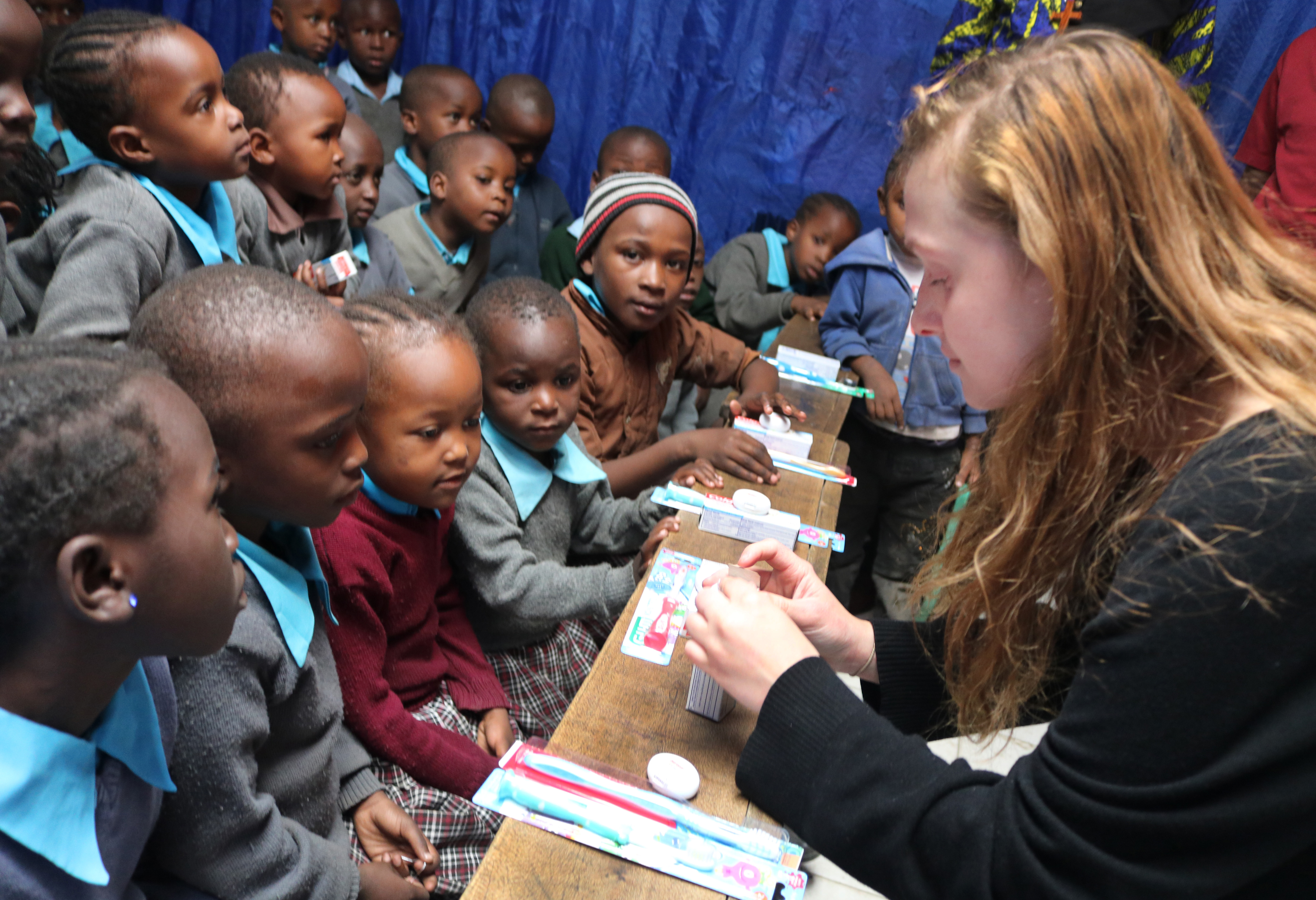 Grace Wall from Clarksbury United Methodist Church in Harmony, N.C., teaches students at New Hope Education Center how to brush and floss their teeth effectively. The primary school, run by Huruma United Methodist Church, supports orphans and other vulnerable children in the Mathare Valley slums on the eastern side of Nairobi, Kenya. Photo by Gad Maiga, UM News.