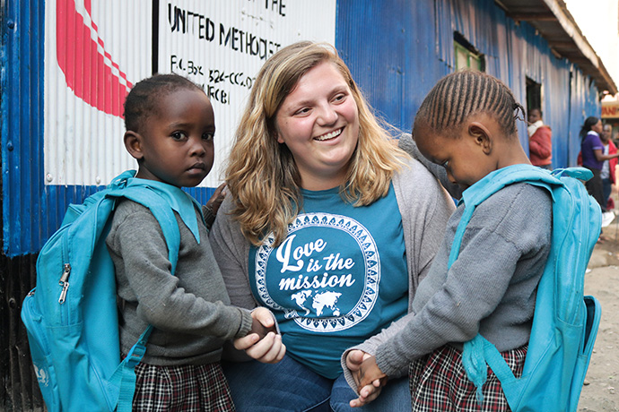Rachel Imbwaga (left), 5, and Miriam Nduku, 4, visit with Carly Etzkorn of Clarksbury United Methodist Church in Harmony, N.C., during the church’s 2019 mission trip. Both girls are orphans and kindergarten students at New Hope Education Center, a primary school run by Huruma United Methodist Church in the Mathare Valley slums on the eastern side of Nairobi, Kenya. Photo by Gad Maiga, UM News.