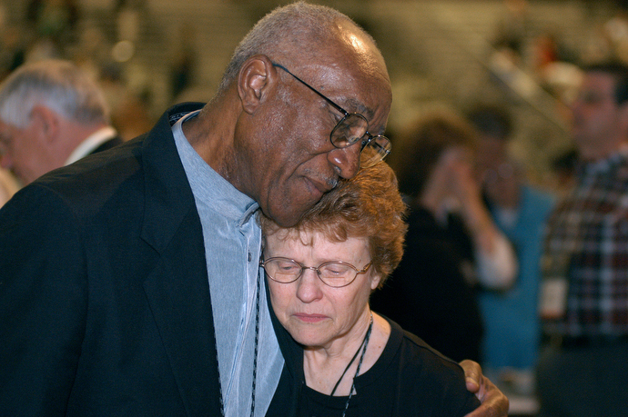 Delegates Burnham A. Robinson (left) and Judith A. Sands embrace following a vote affirming unity in the United Methodist Church at the close of the denomination's 2004 General Conference in Pittsburgh. Talk before the upcoming 2020 General Conference in Minneapolis is about dividing the church. File photo by John C. Goodwin, UM News.