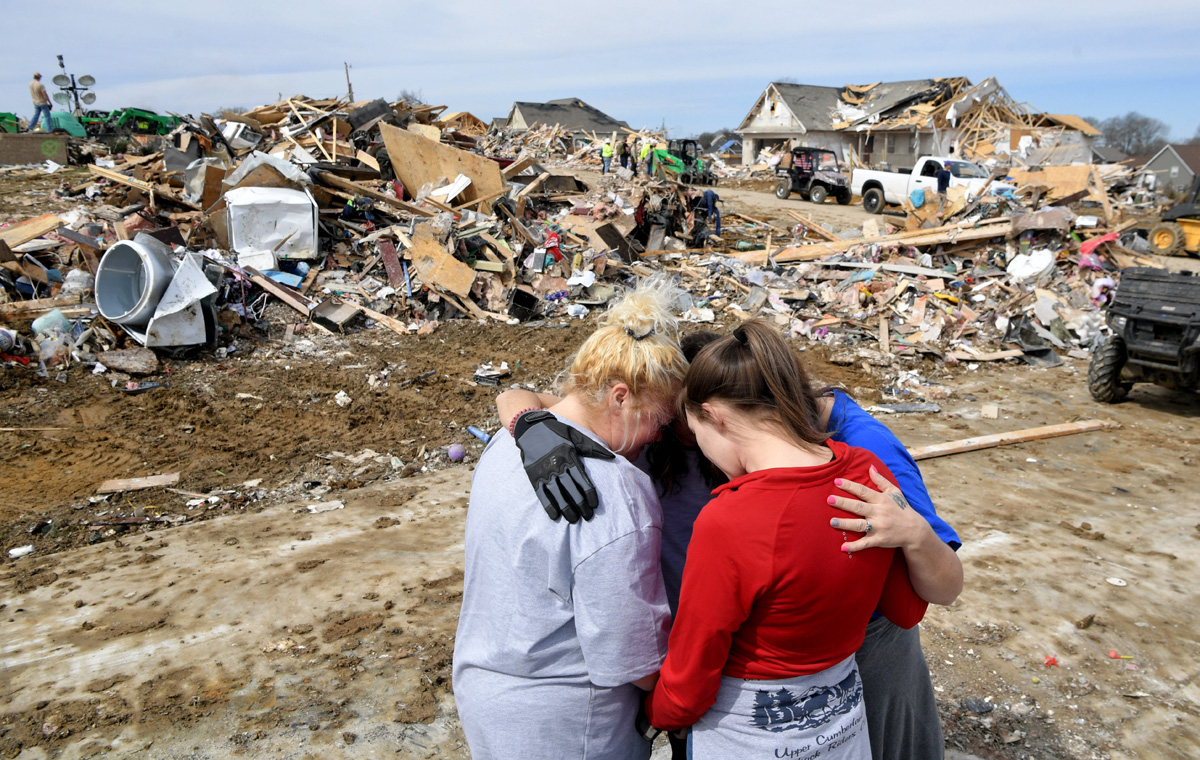 Donna Barnett and daughter Jessica Garrett are hugged and given a prayer by Lindsey Holloway and Melody Montgomery Wednesday, March 4, 2020, in Cookeville, Tenn., after a tornado touched down earlier in the week. © Shelley Mays/The Tennessean – USA TODAY Network via Imagn Content Services, LLC.
