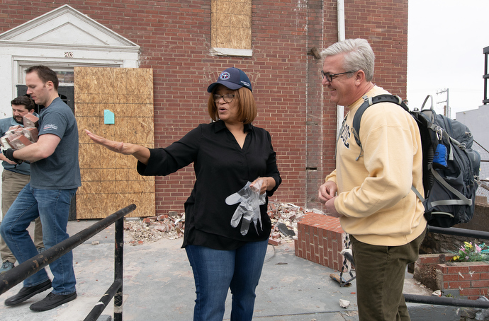 The Rev. Sheila Peters of Braden Memorial United Methodist Church in Nashville, Tenn., shows the Rev. Paul Purdue of Belmont United Methodist Church in Nashville where a volunteer team from Belmont could begin helping clear tornado debris from in front of the church. Photo by Mike DuBose, UM News.