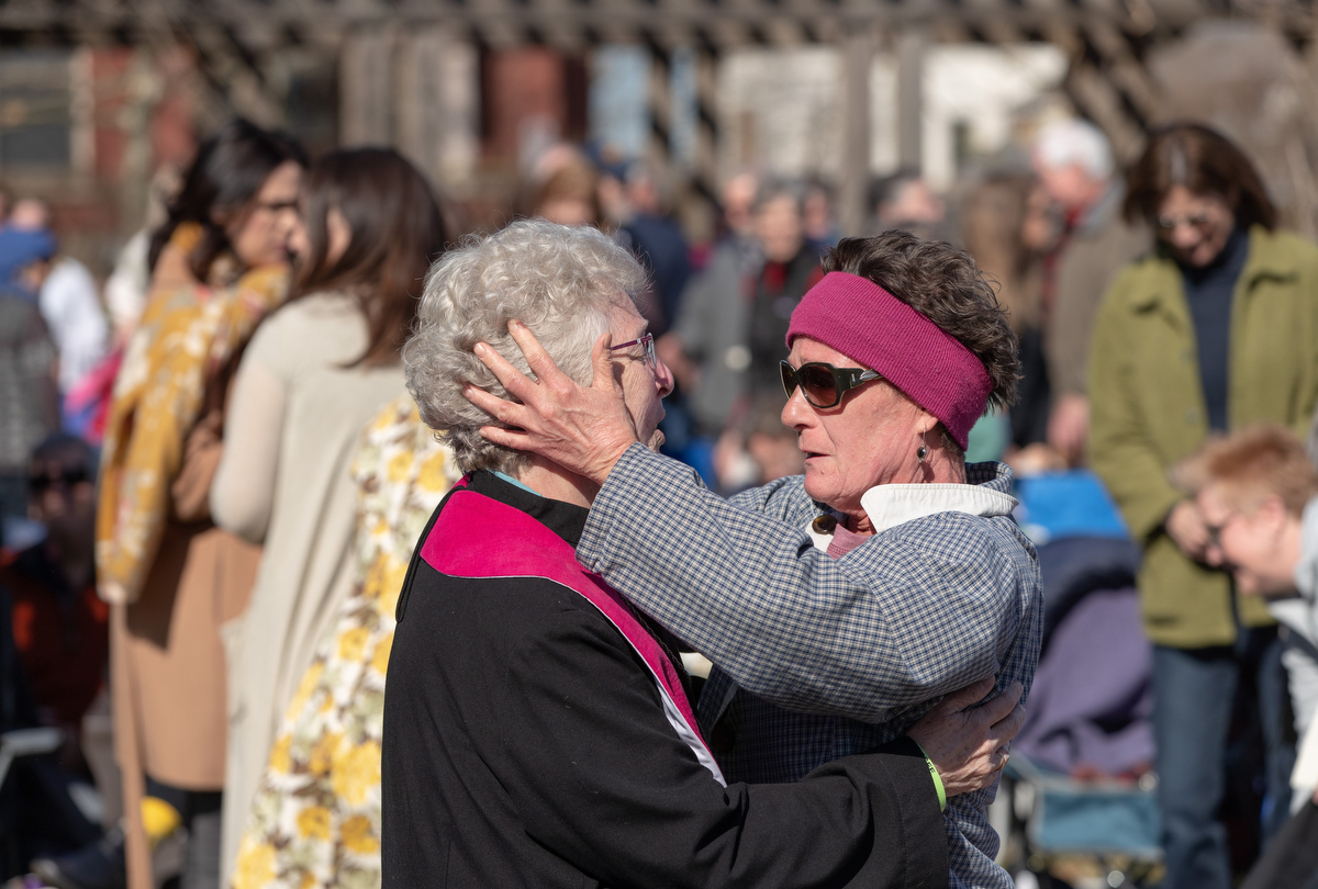 Church member Rita Wigger (right) embraces the Rev. Judi Hoffman during an outdoor worship service in the park adjacent to East End United Methodist Church in Nashville, Tenn. The church building was heavily damaged by a March 3 tornado. Photo by Mike DuBose, UM News.