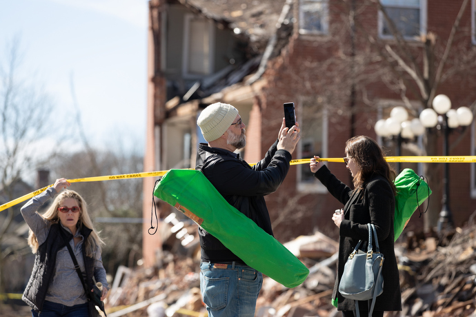 Craig Brewer (center) and Jamie Rosengard (right) view damage to East End United Methodist Church in Nashville, Tenn., following an outdoor worship service in the adjacent park. The church building was heavily damaged in a March 3 tornado. Photo by Mike DuBose, UM News.