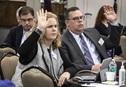 Christine Dodson and the Rev. David Bell, General Council of Finance and Administration board members, raise their hands during a meeting at Scarritt Bennett Center in Nashville, Tenn. The board voted to send the smallest budget the General Conference in more than 30 years. Photo by Kathleen Barry, UM News.