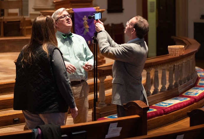 Volunteer Mike Graves (right) prepares to livestream the 10:30 a.m. worship service at Belmont United Methodist Church in Nashville, Tenn., Sunday, March 15, 2020. Church leadership encouraged people to worship from home via the livestream in response to the coronavirus. Helping prepare are Cindy Caldwell (left) and the Rev. Paul Purdue, Belmont’s senior pastor. Photo by Mike DuBose, UM News.