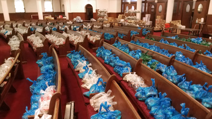 Food parcels line the pews at the United Methodist Church of St. Paul & St. Andrew in New York. The West Side Campaign Against Hunger — a supermarket-style food pantry program founded and actively supported by St. Paul & St. Andrew — has moved its operations there from the basement’s fellowship hall. Starting the week of April 6, the ministry will begin bagging food for Bellevue Hospital in Manhattan. Photo by the Rev. K Karpen.
