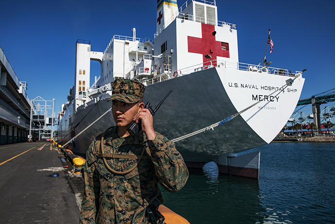 U.S. Marine Corps Pfc. Arnoldo Romero Velazco helps guard the hospital ship USNS Mercy in Los Angeles, where it has been deployed in support of the nation’s COVID-19 response efforts. California Gov. Gavin Newsom spoke of the need for religious communities to support the state’s shelter-in-place order during a conference call with religious leaders. Photo by Cpl. Alexa M. Hernandez, U.S. Marine Corps.