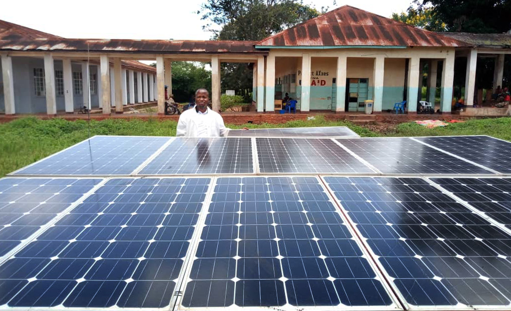 Dr. Joseph Kayembe Katongola stands in front of United Methodist Kabongo Hospital’s new solar panel station. Doctors at the hospital in Kabongo, Congo, had been operating by candlelight before the system was installed earlier this year. Photo by Faustin Kabila Mande.