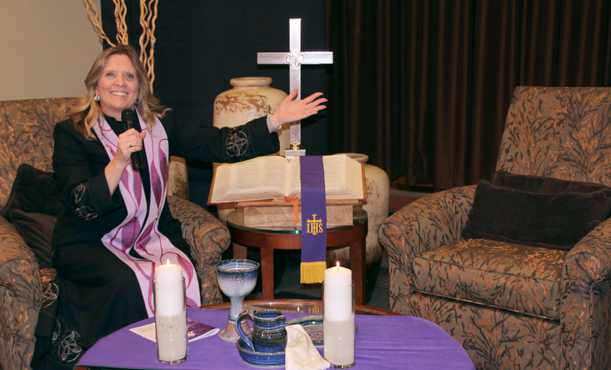The Rev. Kellie Sanford leads a worship service by closed circuit television at the CC Young Senior Living facility in Dallas. Photo by Jennifer Griffin.