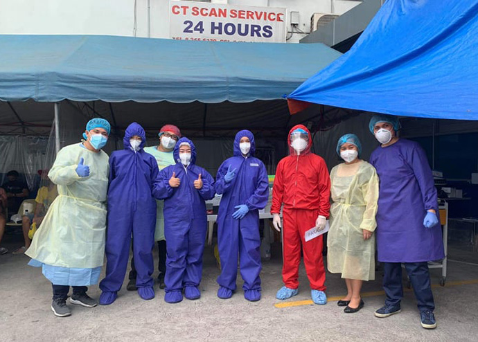 Front line workers at United Methodist Mary Johnston Hospital in Manila, Philippines, put faith above fear as they prepare for another shift treating COVID-19 patients, said Dr. Glenn Roy Paraso (pictured in red). The hospital has six COVID-19 tents set up in the hospital parking lot. Photo  courtesy of Dr. Glenn Roy Paraso. 
