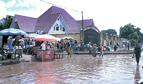 Floodwaters reach the fence and courtyard of Bishop Gabriel Yemba Unda’s residence in Kindu, Congo. Photo by Chadrack Tambwe Londe, UM News.