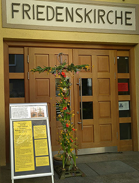 An Easter cross created from the dried trunk of the Christmas tree stands outside United Methodist Peace Church in Munich, Germany. The cross is part of an "on the doorstep" campaign created by the church after its closure because of the coronavirus pandemic. Photo by Kurt Junginger.