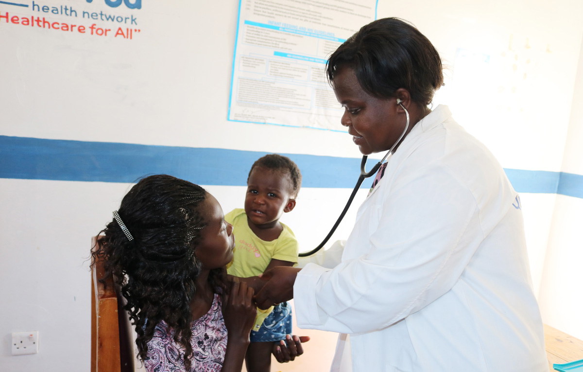 Alice Wasilwa, a registered nurse and maternity clinic manager, attends to a mother and her child during a consultation session at Kopanga Methodist Health Center in Kopanga, Kenya. The United Methodist clinic serves an estimated 1,000 patients per month, providing maternity services including pre- and post-natal care. Photo by Gad Maiga, UM News.
