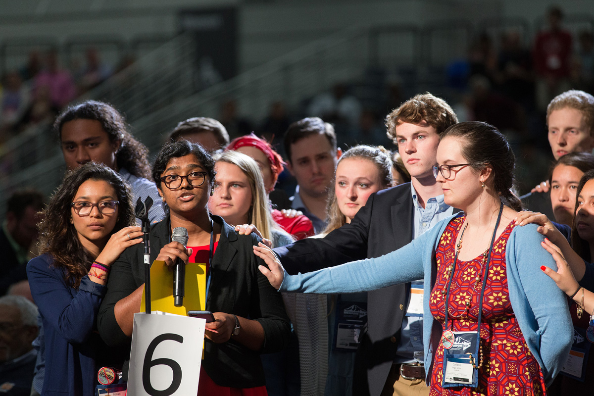 Ann Jacob of the Eastern Pennsylvania Conference is surrounded by other young people as she reads a statement on church unity at the 2016 United Methodist General Conference in Portland, Ore. She is among authors of a petition urging General Conference organizers to reconsider rescheduling General Conference at the start of the academic calendar. File photo by Mike DuBose, UM News.