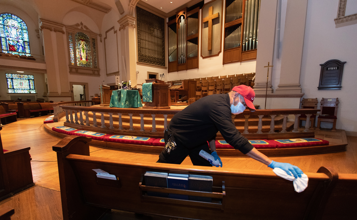 Custodian James Jimmerson disinfects pews to prevent any possible spread of the coronavirus at Belmont United Methodist Church in Nashville, Tenn. on Sunday, May 10, 2020, after online worship, which was recorded in the sanctuary. As churches consider returning to in-person worship, cleaning measures are one of many factors leaders will need to consider. “I believe my job, my part in this, is to make sure people are safe in here,” Jimmerson said. Photo by Mike DuBose, UM News.