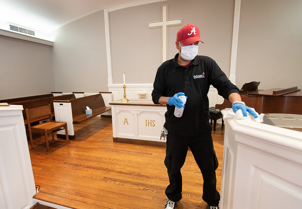 Custodian James Jimmerson disinfects the chancel area to prevent any possible spread of the coronavirus at Belmont United Methodist Church in Nashville, Tenn., on Sunday, May 10, 2020, after online worship, which is recorded in the chapel. Bishops are setting guidelines, including standards for cleaning, and recommending what they think are appropriate times for the churches in their conference to reopen. Photo by Mike DuBose, UM News.